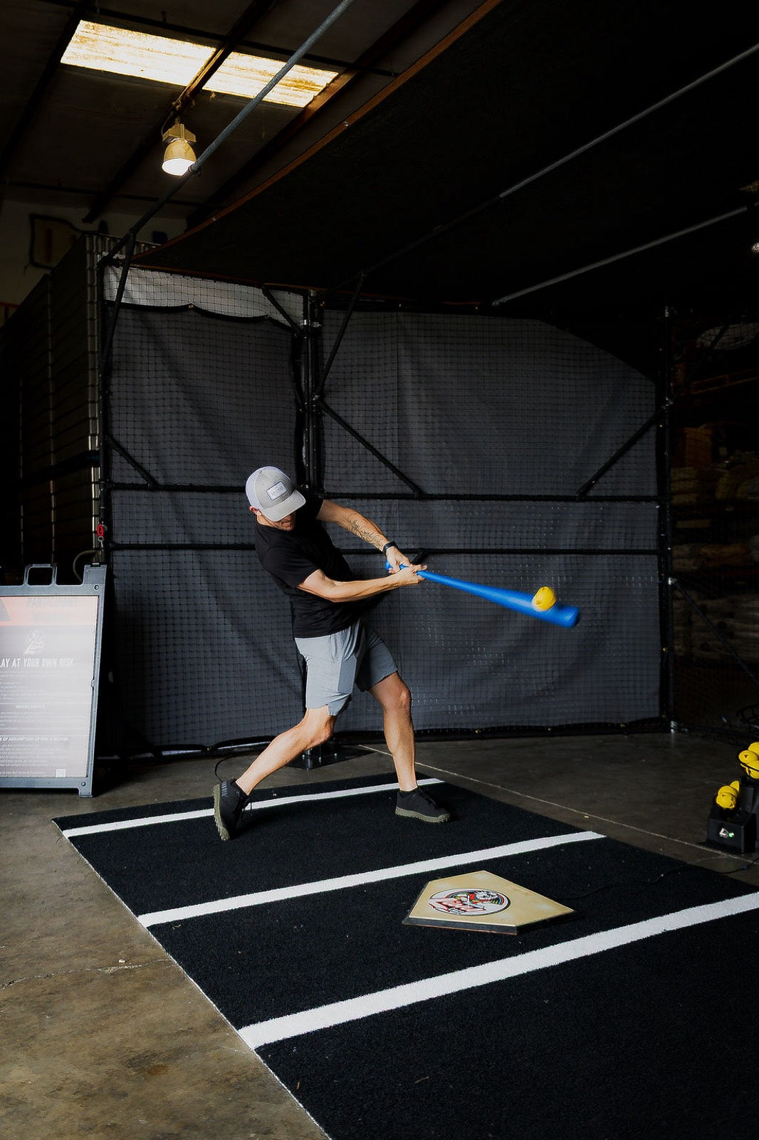 Player swinging at a Lions Cage corporate event